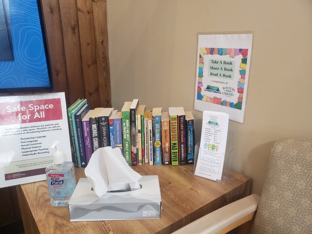 A selection of paperbacks offered by the Bolton Free Library at the Bolton Health Center.