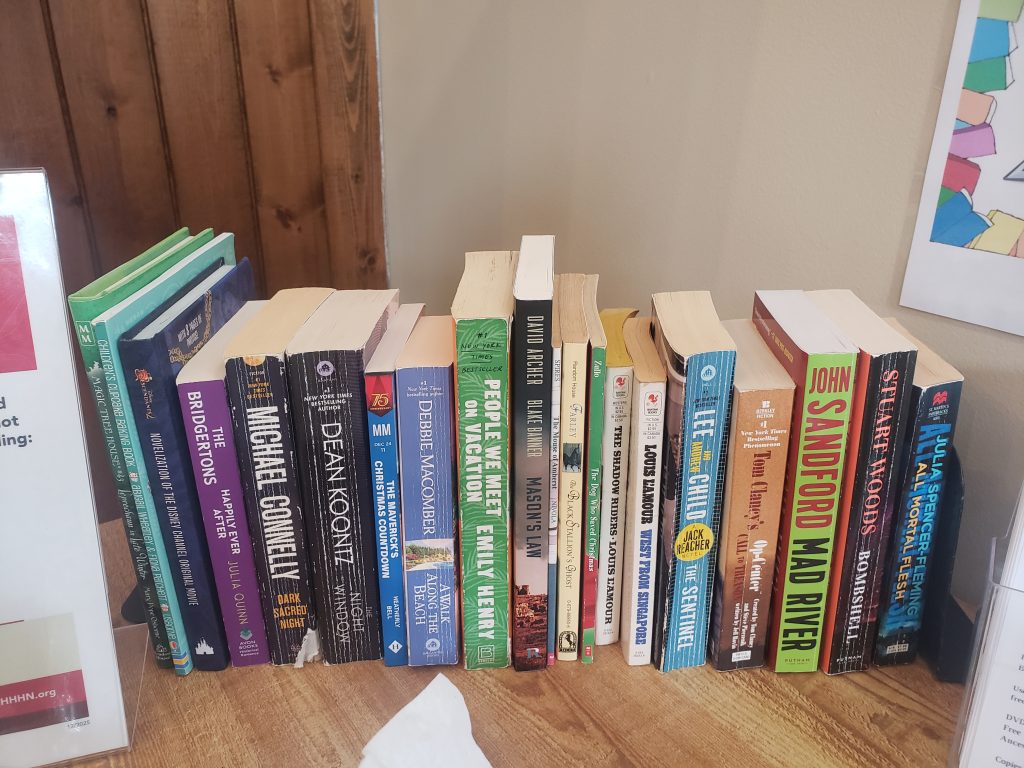 A selection of paperbacks offered by the Bolton Free Library at the Bolton Health Center.